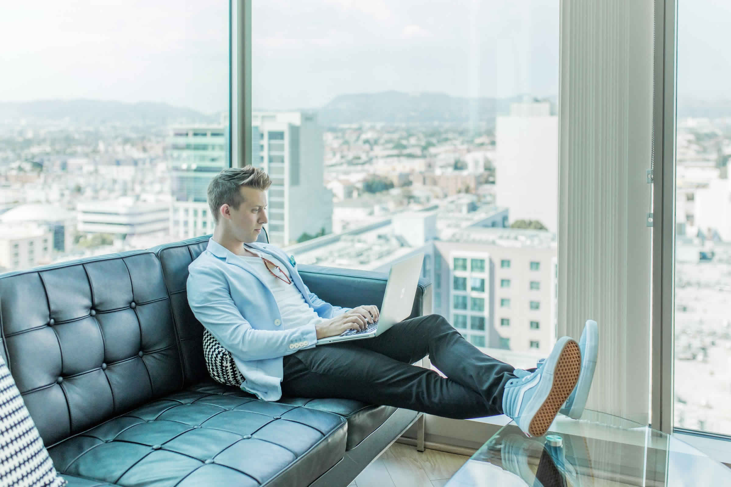 Creative professional working with a laptop in a bright workspace